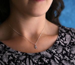 Tiny Angel on 16" Cable Chain {"urlParam":"envisico=%7B%22canvas%22%3A%22f5e1774%22%2C%22layers%22%3A%5B%7B%22strand%22%3A%22c8bf052%22%2C%22focal%22%3A%22c8bf017%22%7D%5D%2C%22f%22%3A1%7D"}